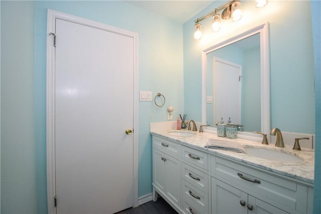 full bathroom featuring double vanity and a sink