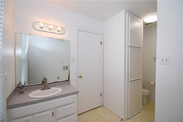 bathroom featuring visible vents, toilet, and vanity