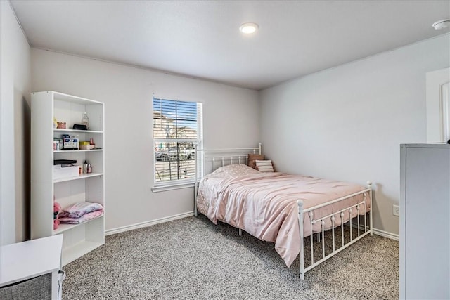 bedroom featuring baseboards and carpet flooring