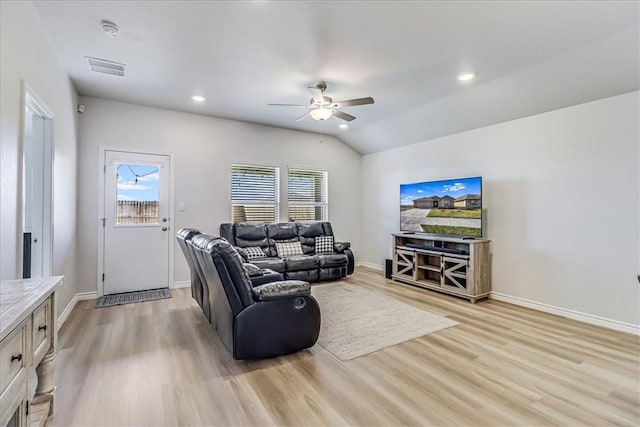 living room with ceiling fan, light hardwood / wood-style floors, and vaulted ceiling