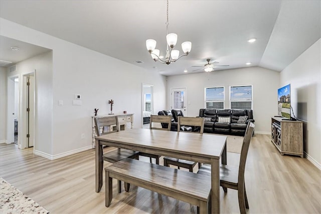 dining area with lofted ceiling, light wood-style flooring, and baseboards