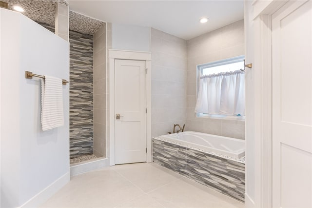 bathroom featuring shower with separate bathtub and tile patterned flooring