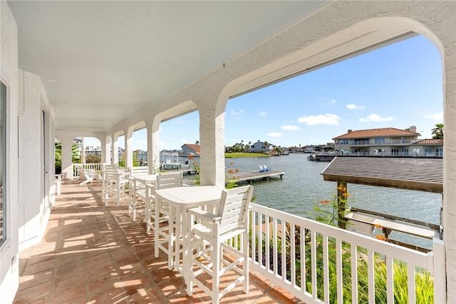 view of patio / terrace with a balcony and a water view