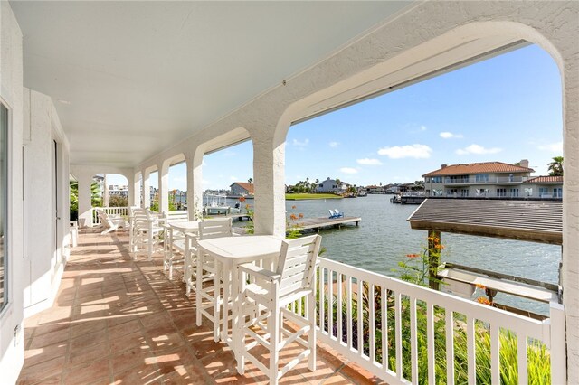 view of patio / terrace with a balcony and a water view