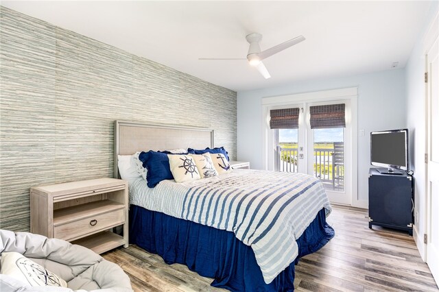 bedroom with hardwood / wood-style flooring, ceiling fan, and access to exterior