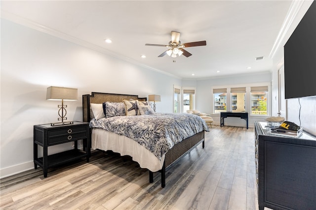 bedroom featuring ornamental molding, wood-type flooring, and ceiling fan