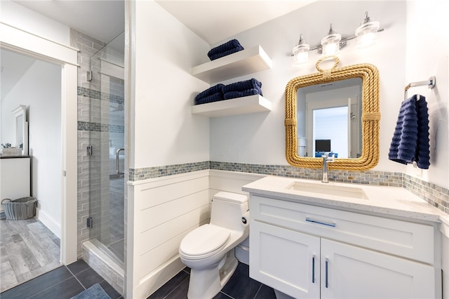 bathroom with toilet, vanity, an enclosed shower, and hardwood / wood-style flooring