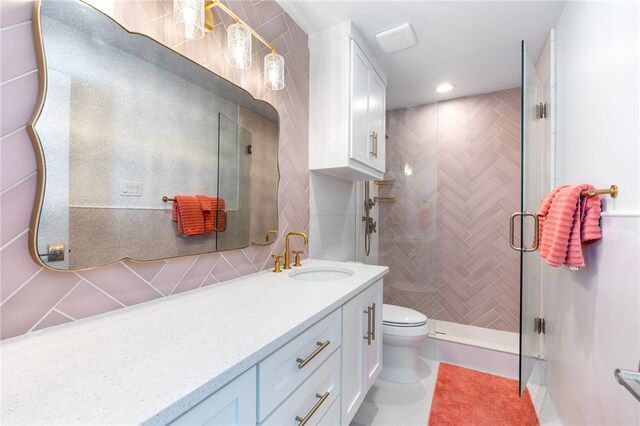 bathroom with walk in shower, tasteful backsplash, vanity, tile patterned floors, and toilet