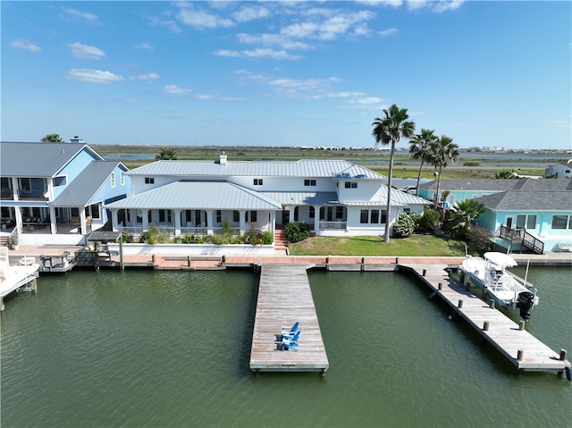 dock area with a water view and a lawn