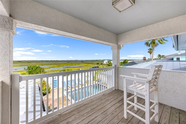 wooden terrace featuring a water view