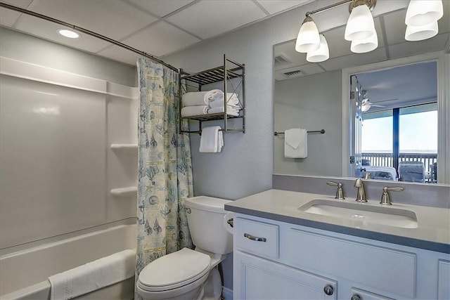 full bathroom with ceiling fan, vanity, shower / tub combo with curtain, and toilet