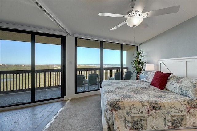 bedroom featuring ceiling fan, access to exterior, floor to ceiling windows, and multiple windows