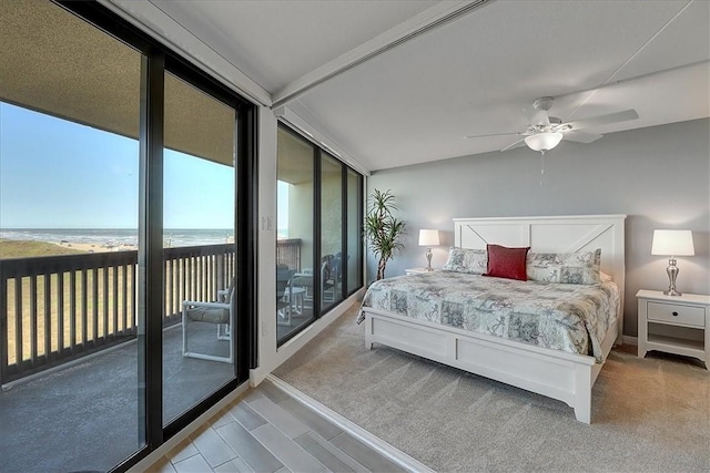 bedroom featuring floor to ceiling windows, access to exterior, a water view, a view of the beach, and ceiling fan