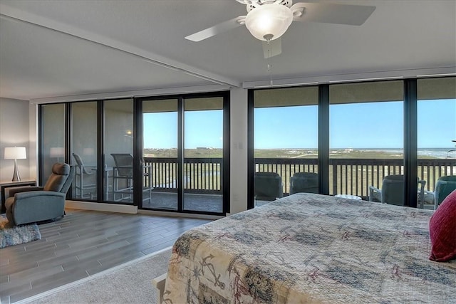 bedroom with ceiling fan, access to exterior, and multiple windows