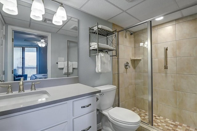 bathroom with an enclosed shower, vanity, ceiling fan, and toilet