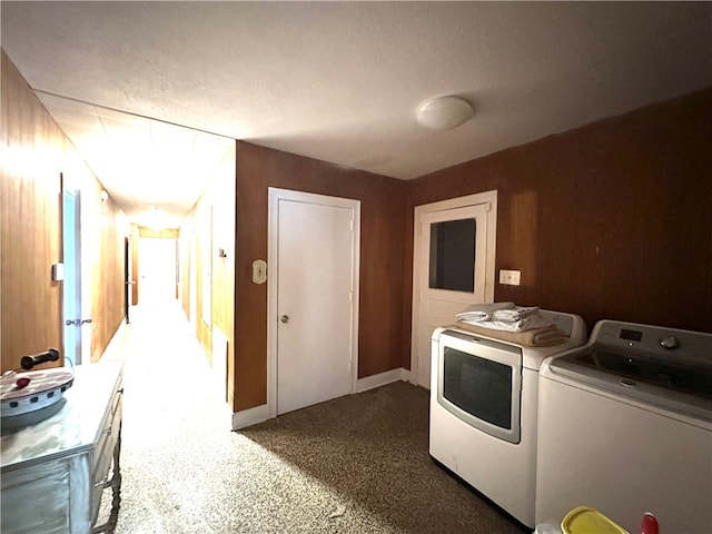 laundry room with a textured ceiling and washer and clothes dryer