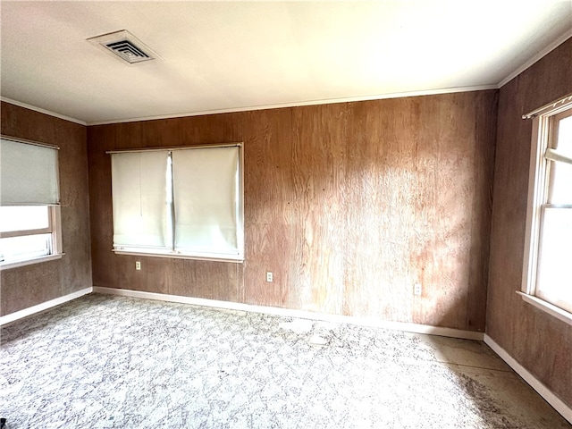 unfurnished room featuring wood walls