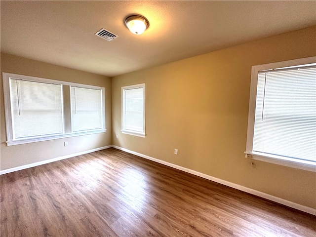 spare room with hardwood / wood-style flooring