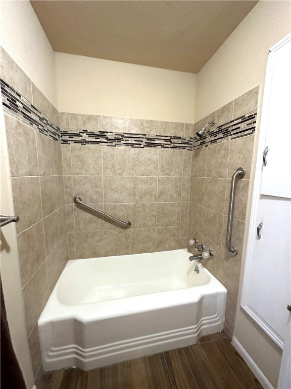 bathroom featuring tiled shower / bath and hardwood / wood-style flooring