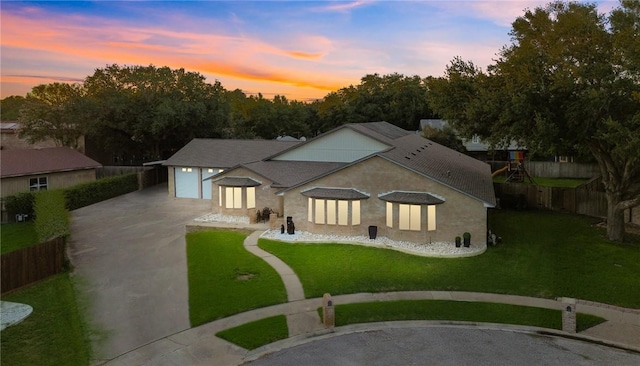 view of front facade featuring a yard and a garage