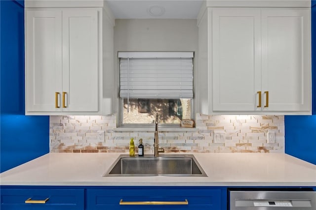 kitchen with tasteful backsplash, white cabinetry, dishwasher, and blue cabinets