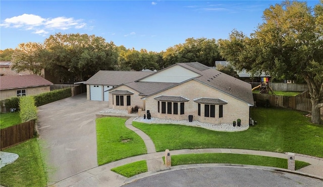 view of front of property featuring a front yard and a garage