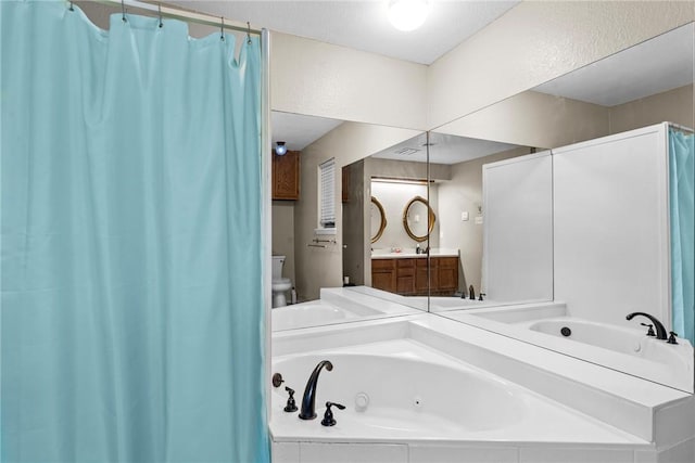 bathroom featuring vanity, toilet, and a bathing tub