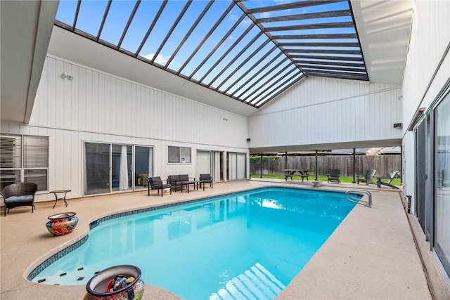 view of pool featuring a patio area, an outdoor living space, and a diving board