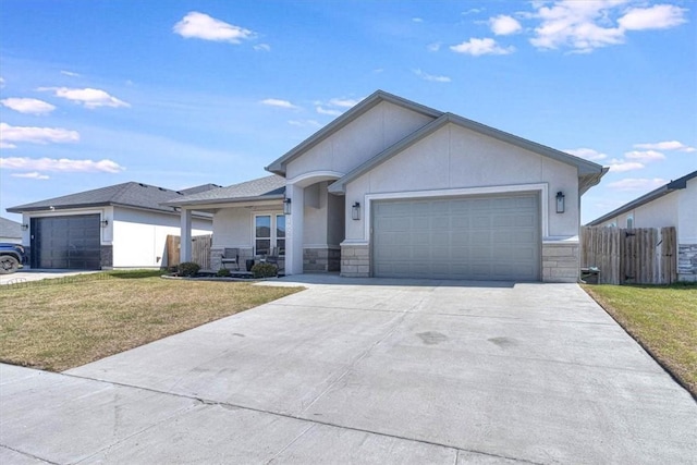 view of front of property with stone siding, an attached garage, fence, and a front yard