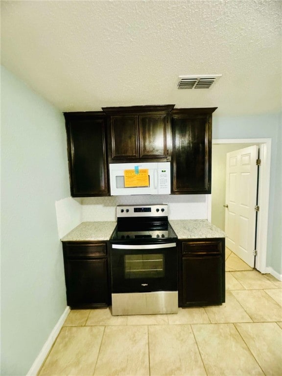 kitchen featuring dark brown cabinets, a textured ceiling, stainless steel range with electric stovetop, and light tile patterned floors