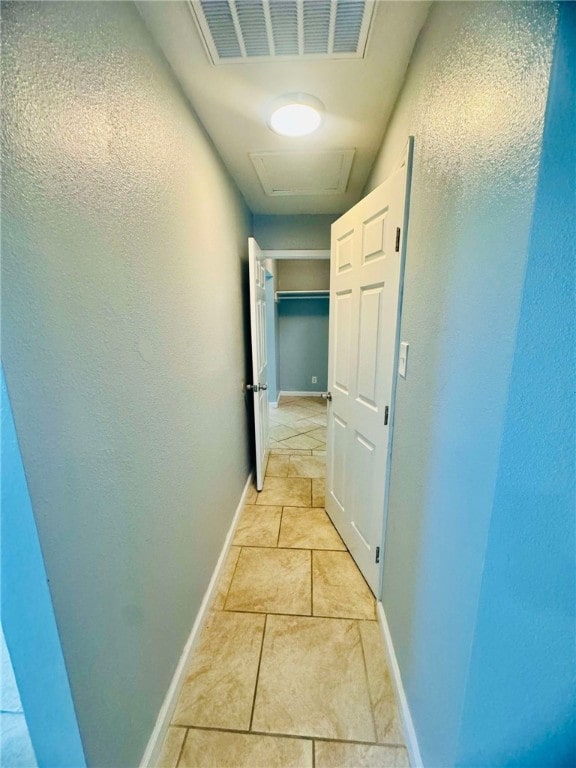 corridor featuring light tile patterned floors