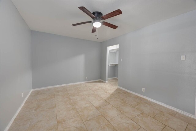 tiled empty room with ceiling fan