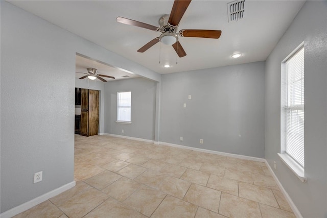 unfurnished room with visible vents, baseboards, and light tile patterned flooring