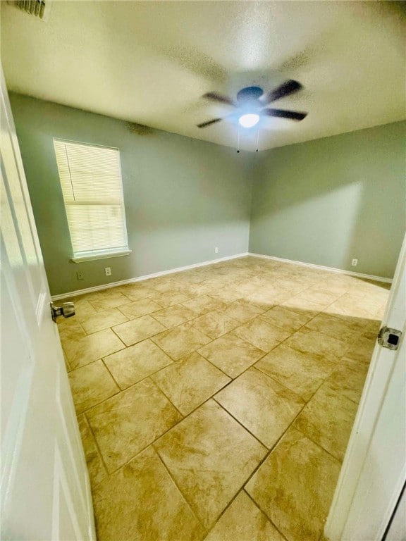 empty room featuring a textured ceiling and ceiling fan