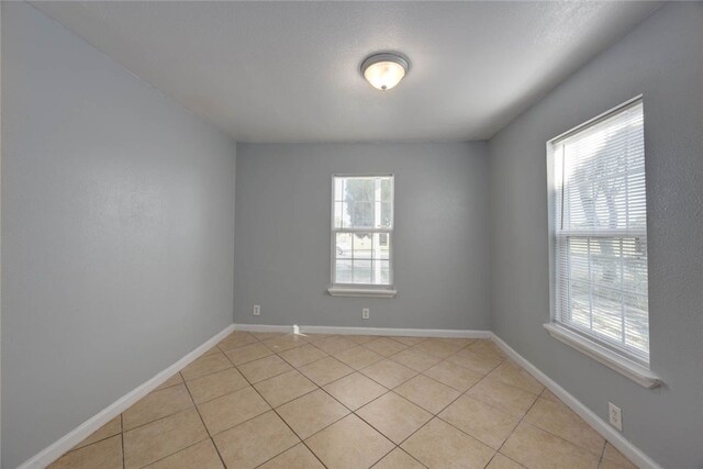 unfurnished living room with ceiling fan and light tile patterned floors