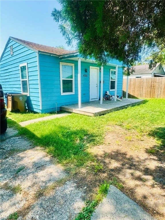 exterior space with a lawn and a wooden deck