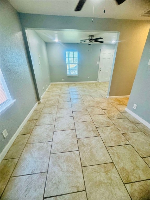 unfurnished room featuring ceiling fan and light tile patterned floors