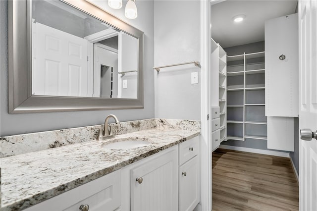 bathroom with vanity and hardwood / wood-style floors