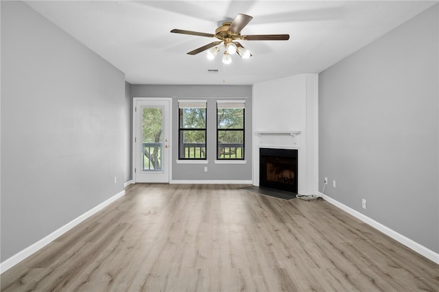 unfurnished living room featuring ceiling fan and light hardwood / wood-style flooring