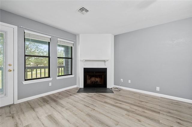 unfurnished living room featuring light hardwood / wood-style floors