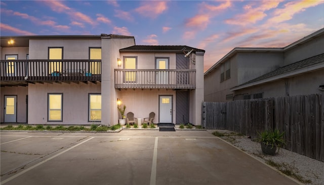 15317 Bonasse Ct Unit 1606, Corpus Christi, TX 78418 - view of front of home with a balcony, uncovered parking, fence, and stucco siding