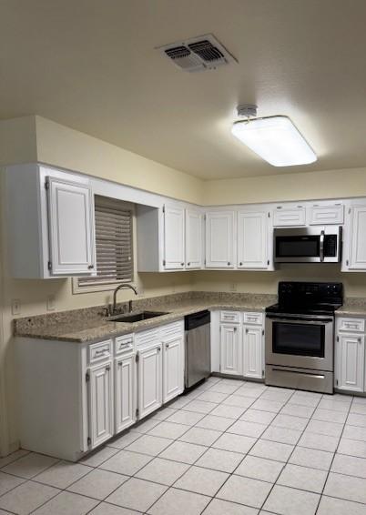4202 Wolf Creek Dr, Corpus Christi, TX 78413 - kitchen featuring stainless steel appliances, white cabinets, and light tile patterned floors