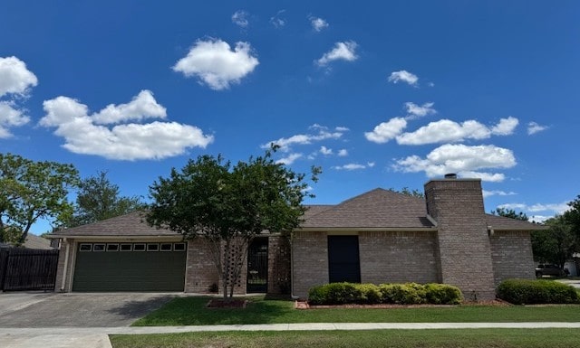 4202 Wolf Creek Dr, Corpus Christi, TX 78413 - ranch-style home featuring an attached garage, driveway, a chimney, and brick siding