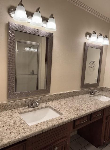 4202 Wolf Creek Dr, Corpus Christi, TX 78413 - bathroom featuring double vanity, crown molding, tile patterned floors, and a stall shower