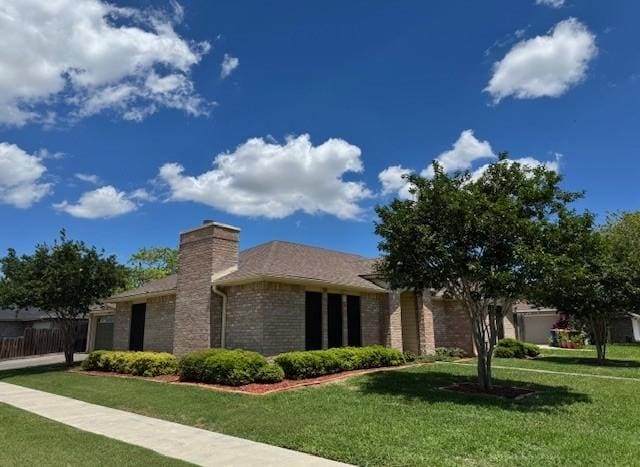 4202 Wolf Creek Dr, Corpus Christi, TX 78413 - view of front facade featuring brick siding and a chimney