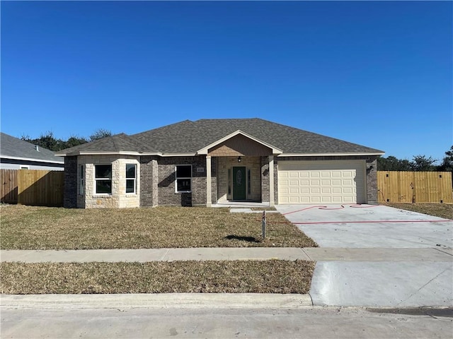ranch-style house featuring roof with shingles, driveway, fence, and an attached garage