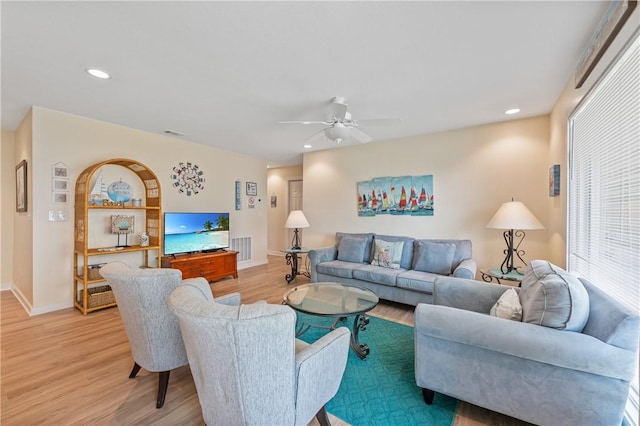 living area featuring visible vents, baseboards, and light wood-type flooring