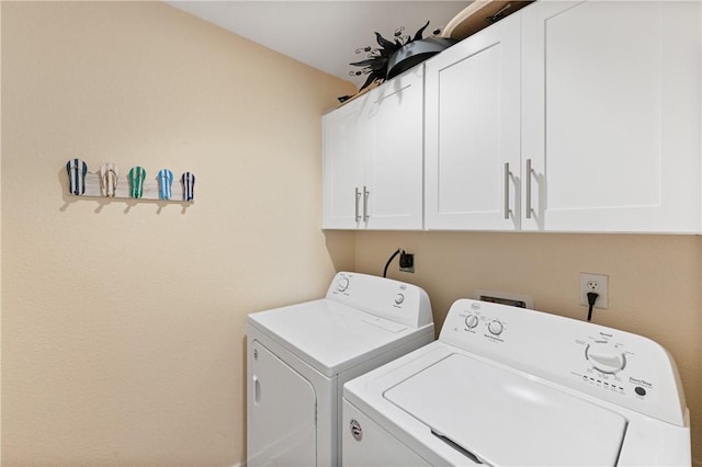laundry area with cabinet space and washing machine and clothes dryer