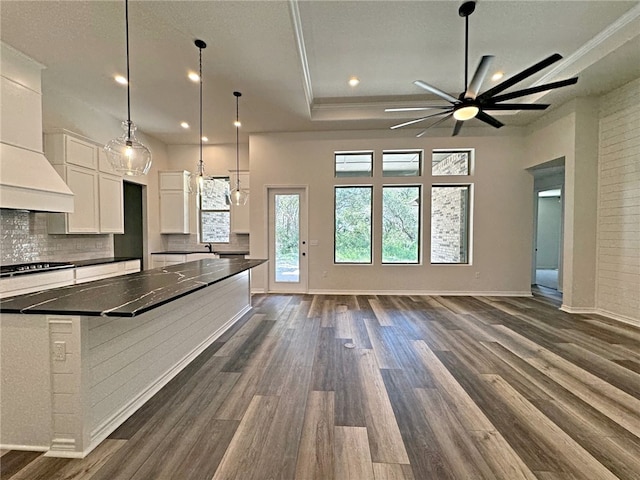 kitchen with dark hardwood / wood-style flooring, hanging light fixtures, and white cabinets