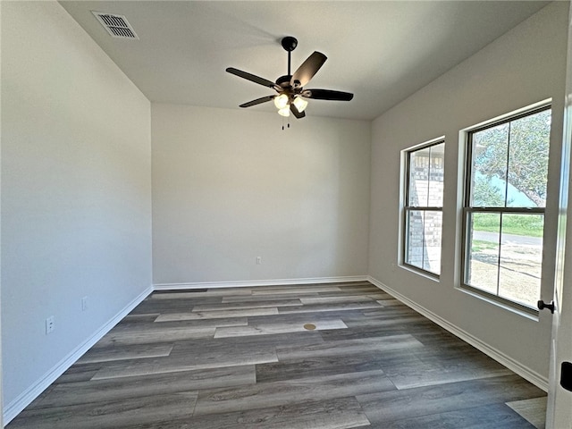 spare room featuring ceiling fan and dark hardwood / wood-style floors